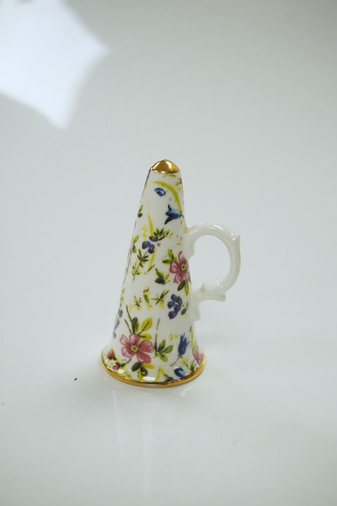 A mixed collection of miniature items including a Royal Worcester hound’s head whistle, a candle extinguisher and a glass tea set, etc., largest 6cm high (6). Condition - good